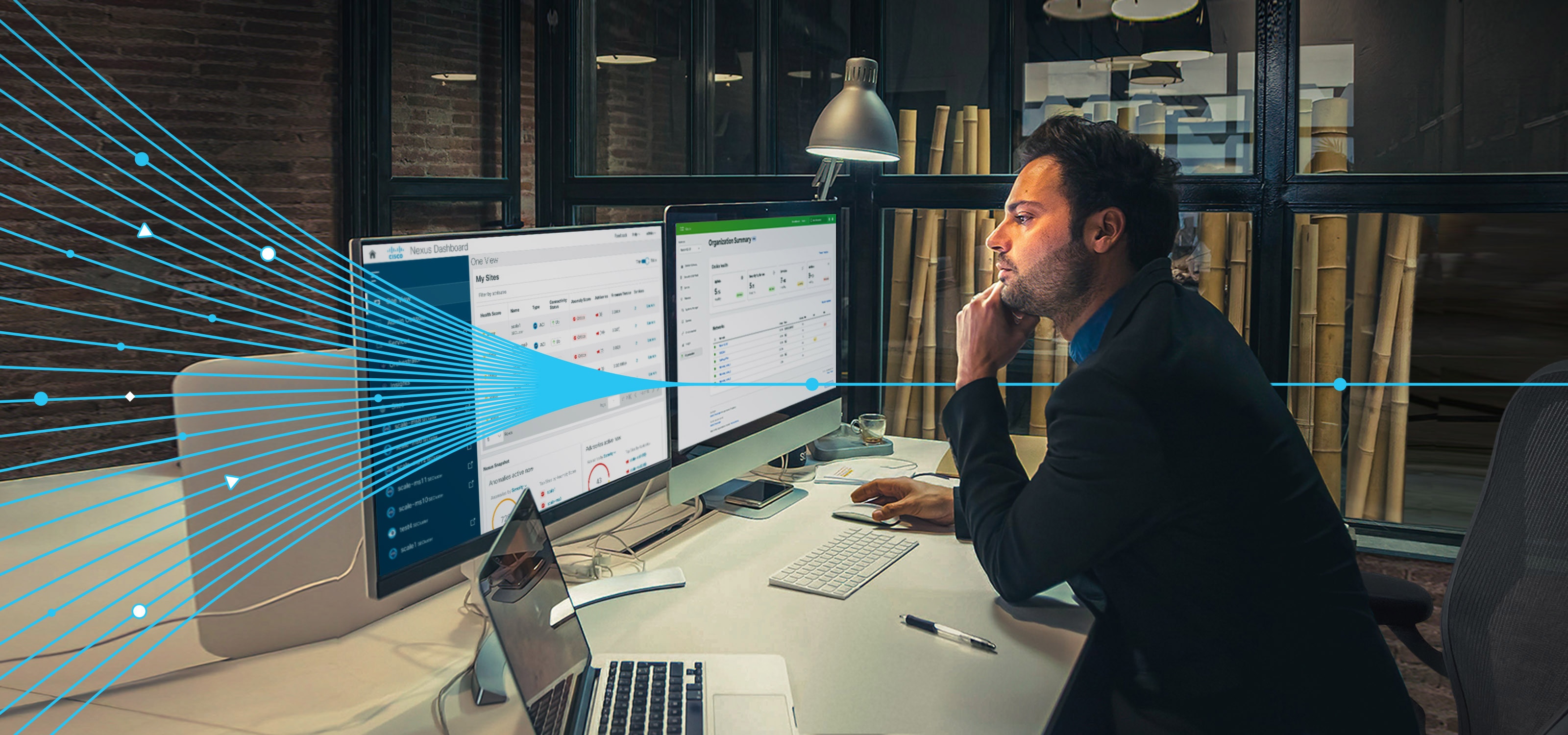 Cisco Transforming Infrastructure brand links over man in office looking at desktop screens looking at Cisco dashboards
