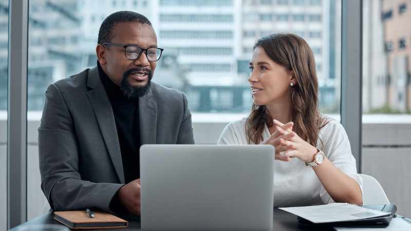 Professionals reviewing a presentation in a conference room